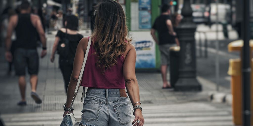 woman walking on lane during daytime