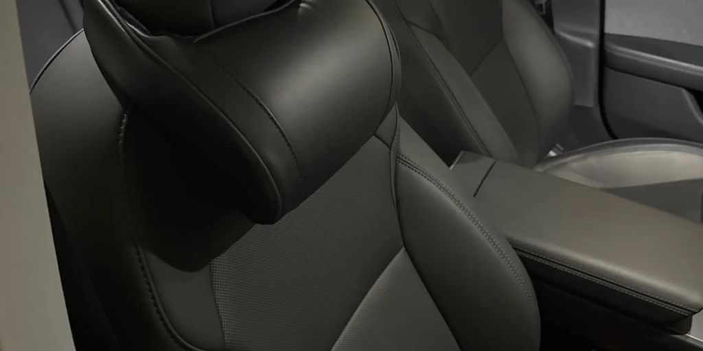 The image shows modern car seats in a sleek interior.