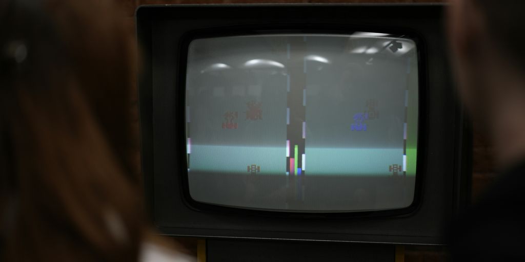 A person standing in front of a TV