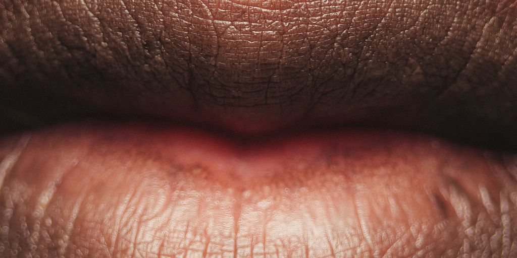 persons lips with red lipstick