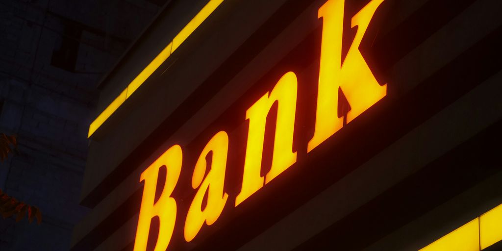 a bank sign lit up in the dark
