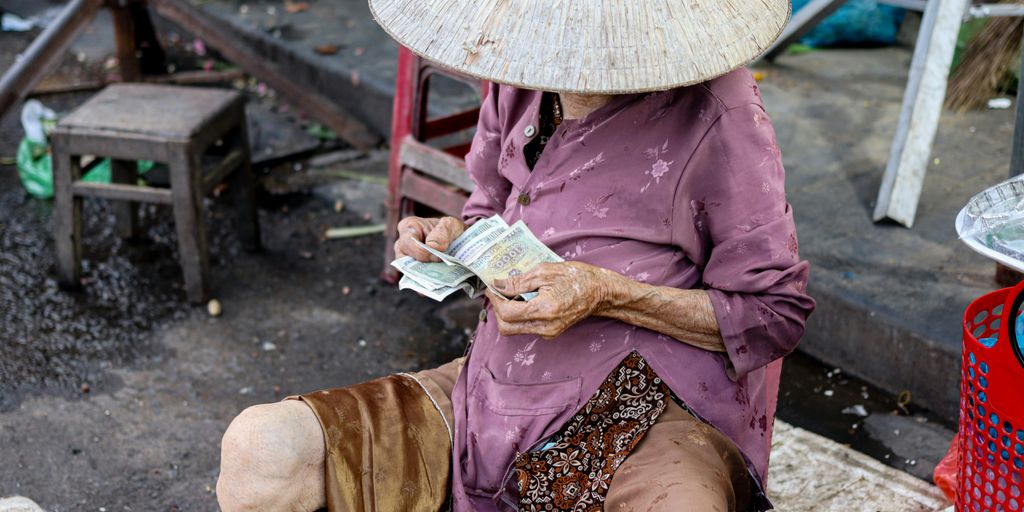 a woman sitting on the ground with a hat on her head