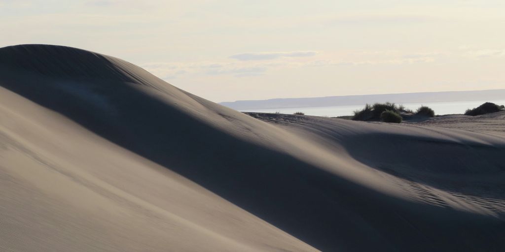 white sand under white clouds during daytime