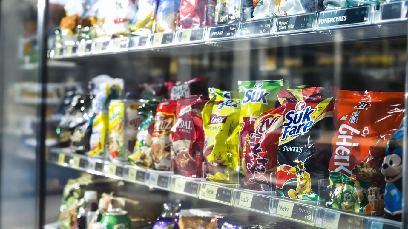 Vending machine stocked with colorful snacks and drinks.