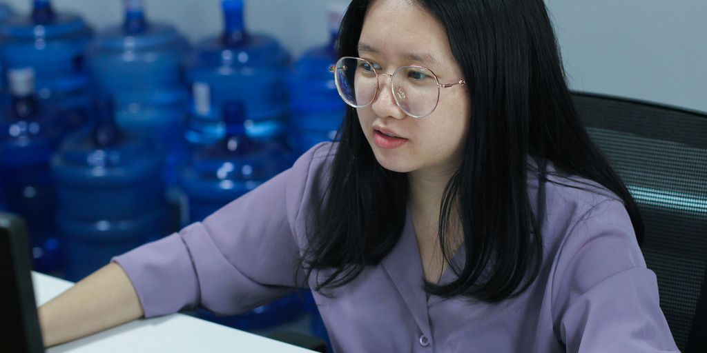 a woman sitting at a desk with a laptop