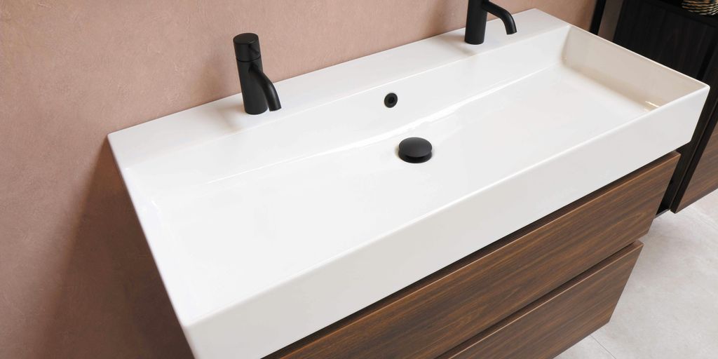 black plastic faucet on white ceramic sink