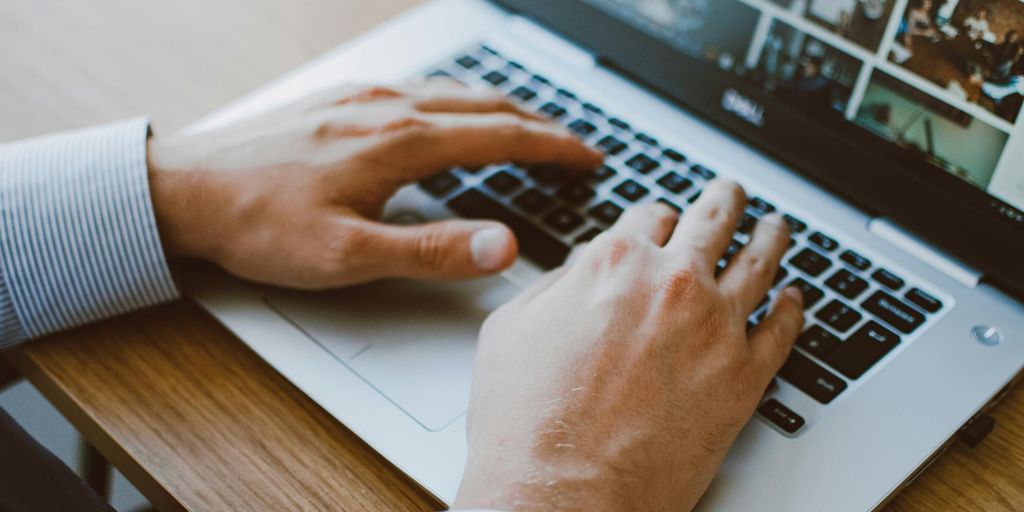 person using a laptop with a lock icon on the screen, symbolizing online privacy