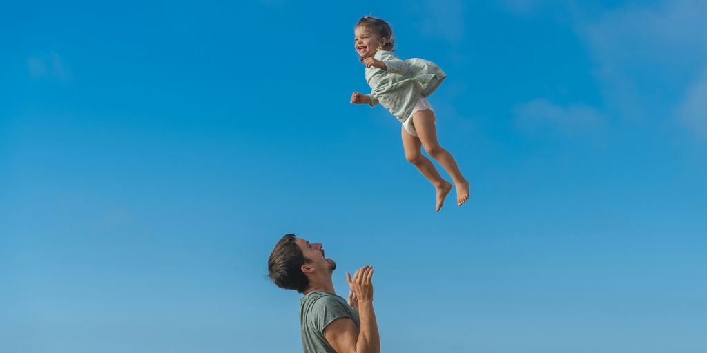 a man and a little girl flying through the air