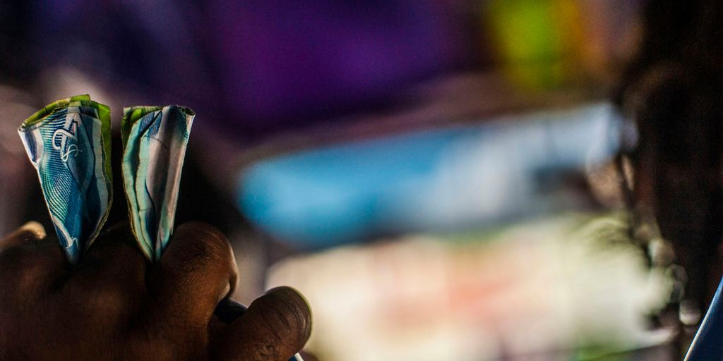 a person holding a piece of money in their hand