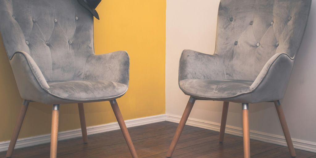 gray padded chair on brown wooden floor
