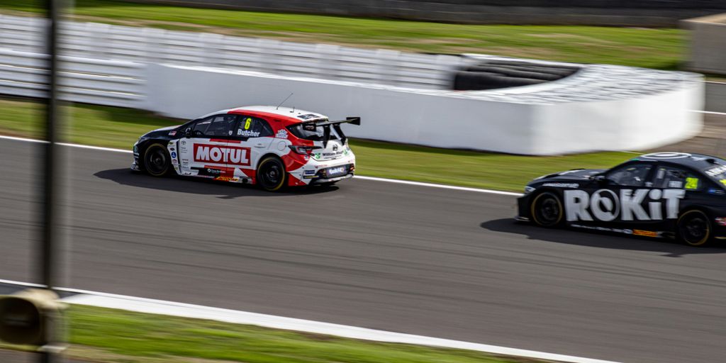 a couple of cars racing on a race track
