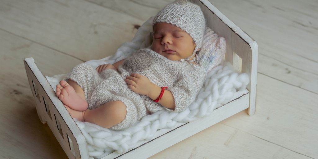 a baby is sleeping in a wooden box
