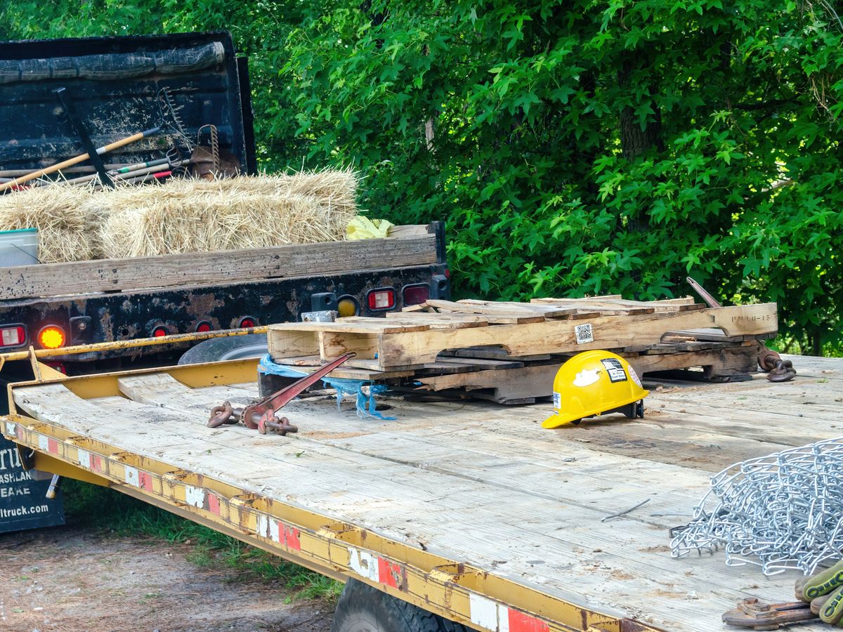 yellow and black heavy equipment on brown wooden pallet