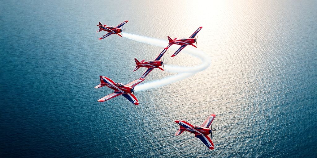 Avions de voltige effectuant des manœuvres au-dessus de la mer.
