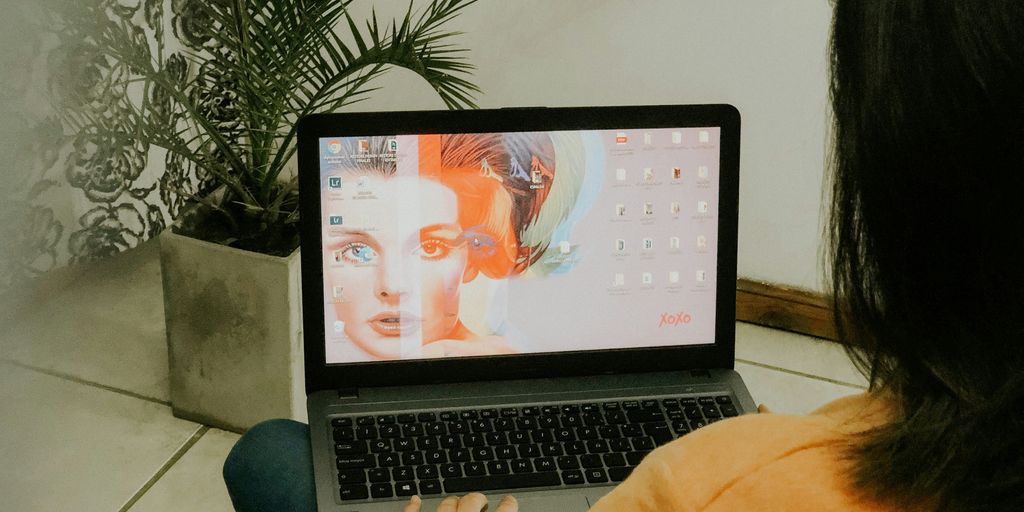 woman in yellow long sleeve shirt using macbook pro