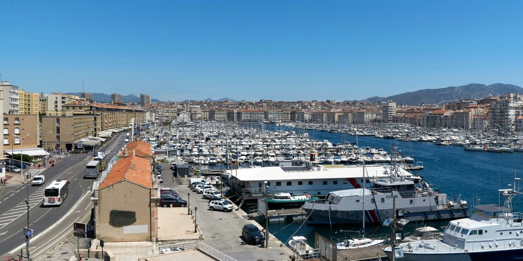 a marina with boats and cars