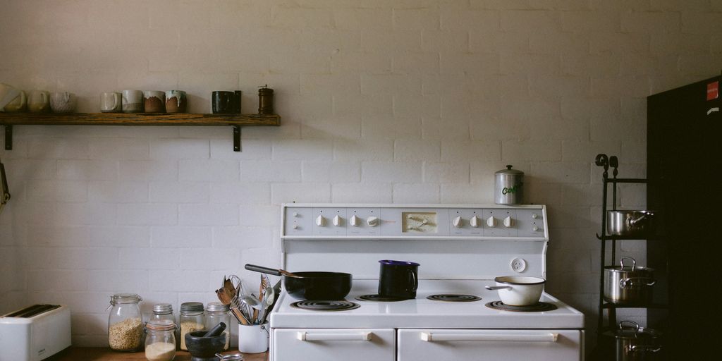 white gas range oven with cooking pots