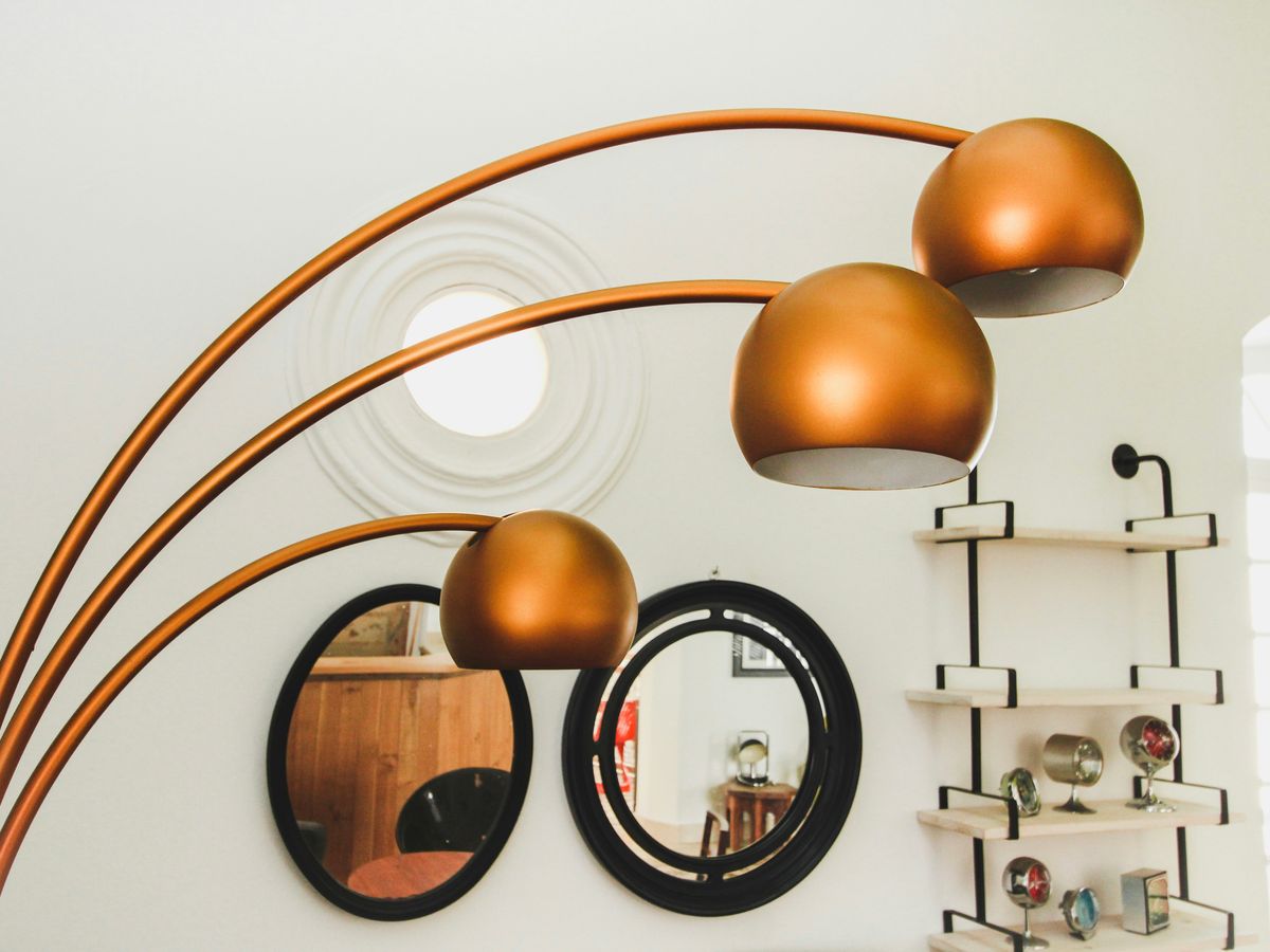 brass-colored 3-light floor lamp inside room