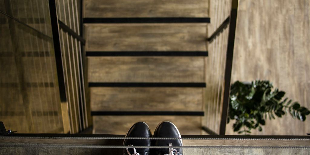 person standing near railing looking down