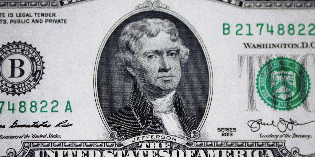 us dollar bill on black and white textile