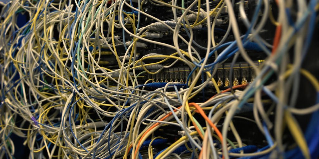 Technicians installing structured cabling in a modern office.