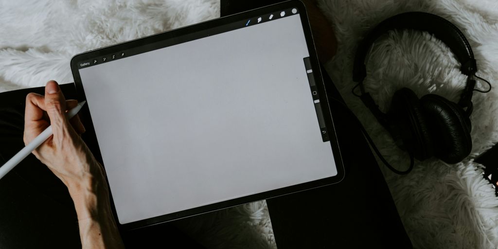black tablet computer on white textile