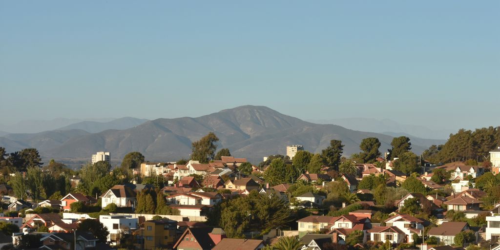a group of houses with trees in the back