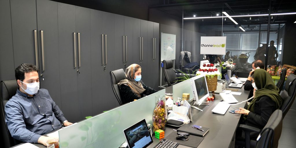 man in black jacket sitting on black office rolling chair