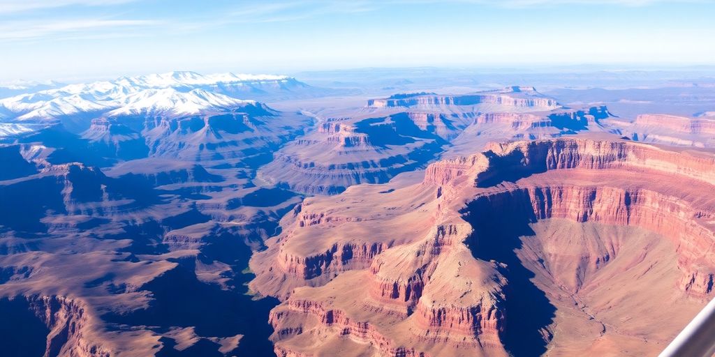 A small tour plane flies above dramatic mountains and canyons.