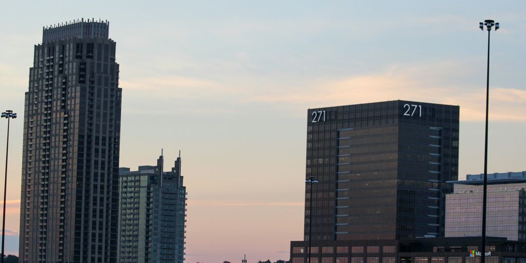 a couple of tall buildings sitting next to each other