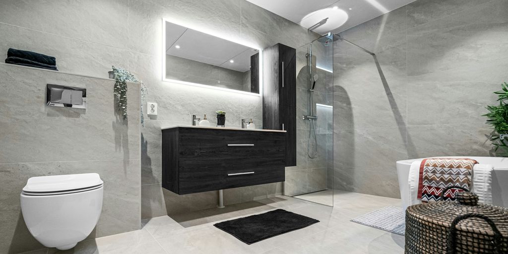 A bathroom with a toilet, sink, and mirror