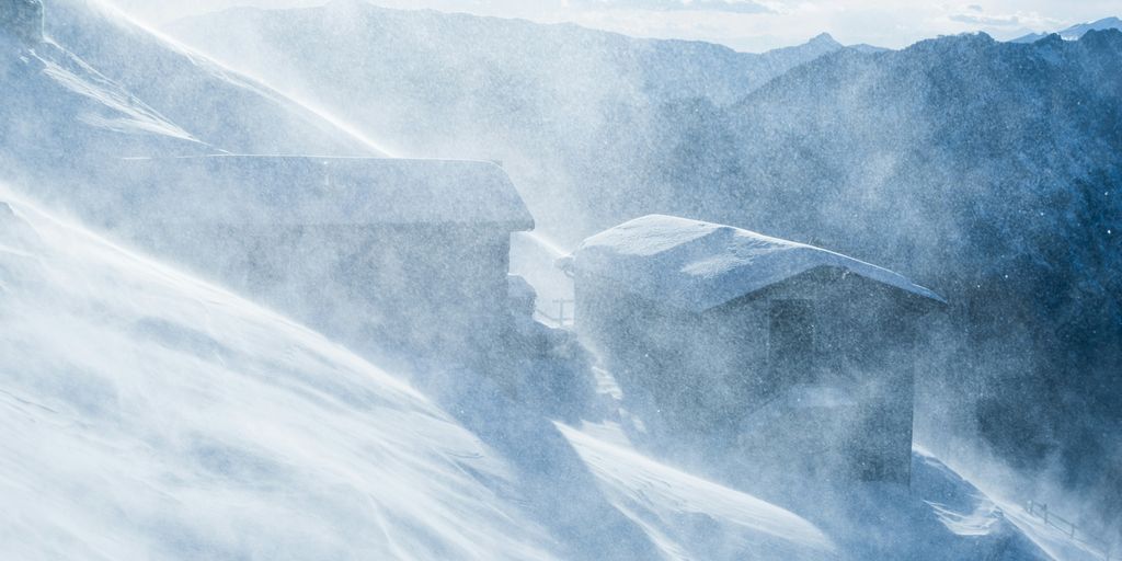 two cabins covered with snow