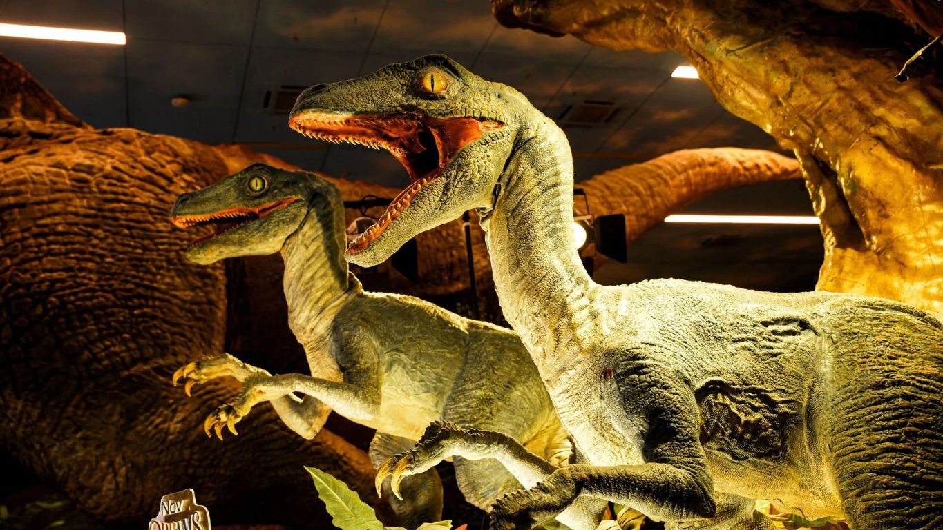 Dinosaurs displayed in a museum exhibit, showcasing detailed models.