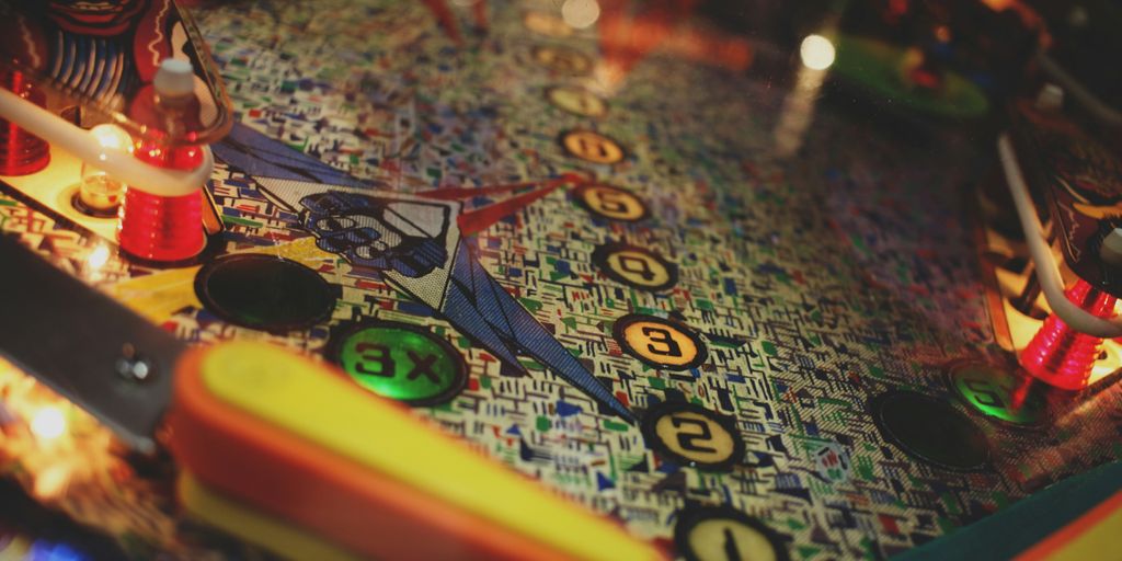 a close up of a pinball machine with a lit candle