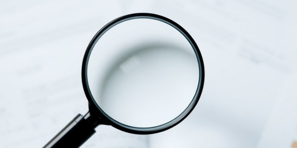 Magnifying glass over documents