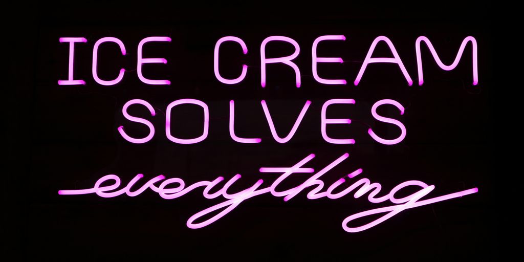 A neon sign that says ice cream solves everything