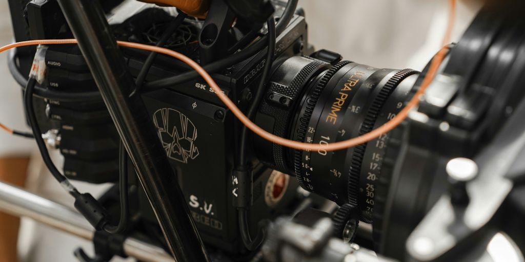 a close up of a camera with a hand on it