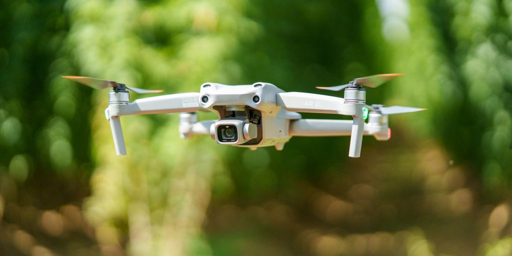 A close up of a camera attached to a small white plane