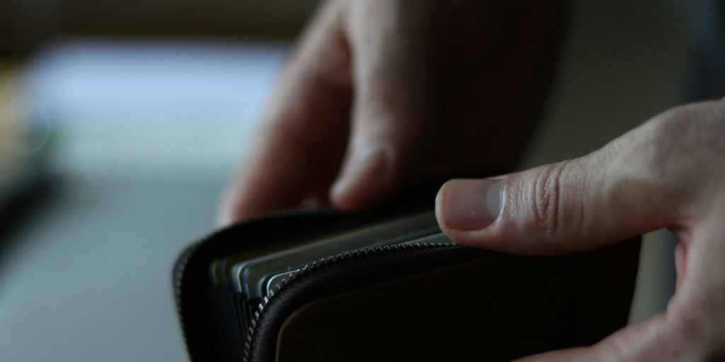 a person holding a wallet in their hand