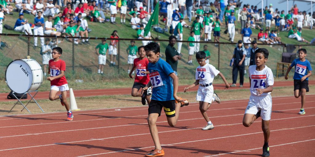 a group of kids running on a track
