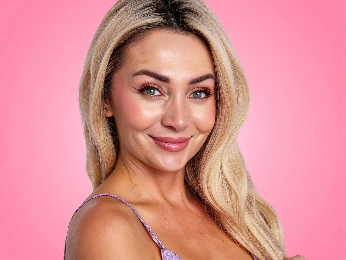 A smiling individual with blonde hair against a pink background.