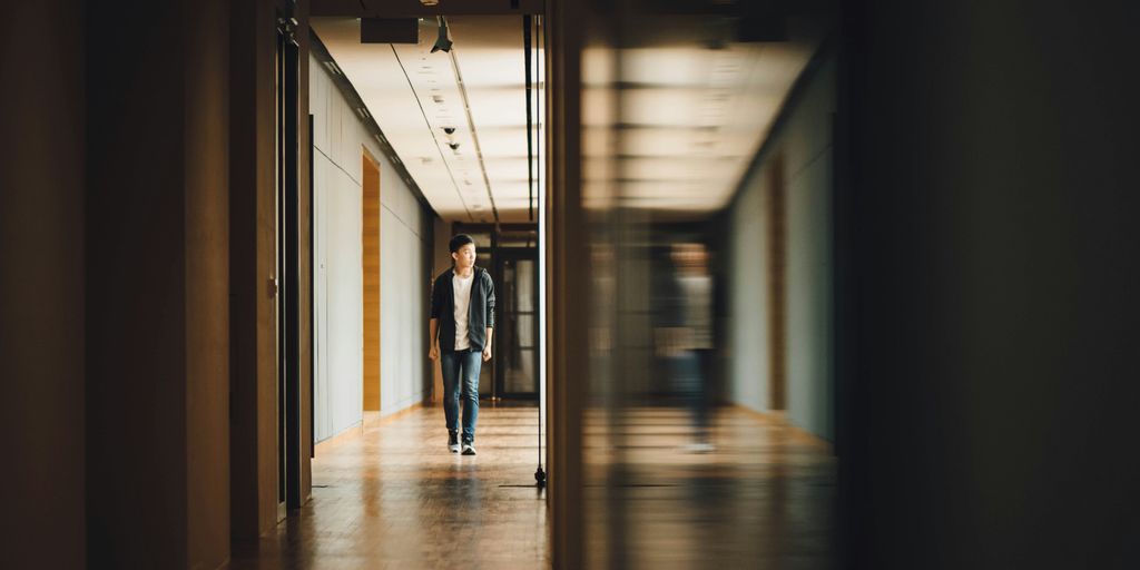 man walking towards opened door