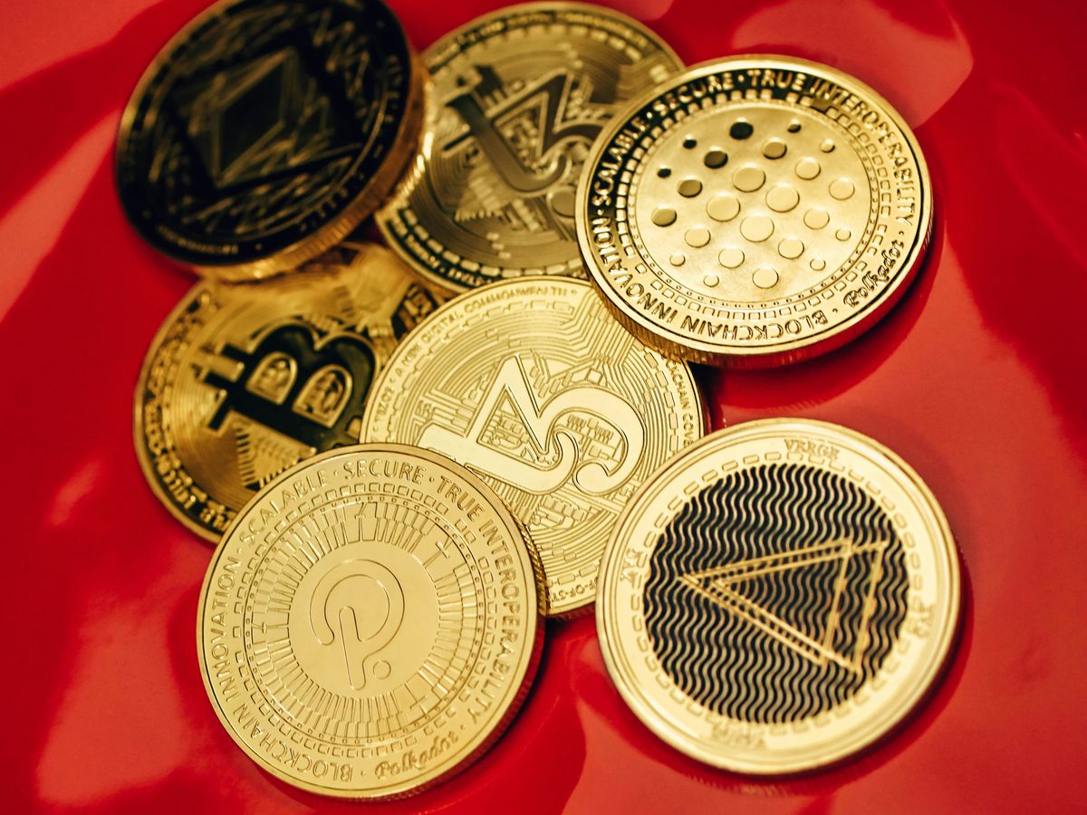 a pile of bitcoins sitting on top of a red table