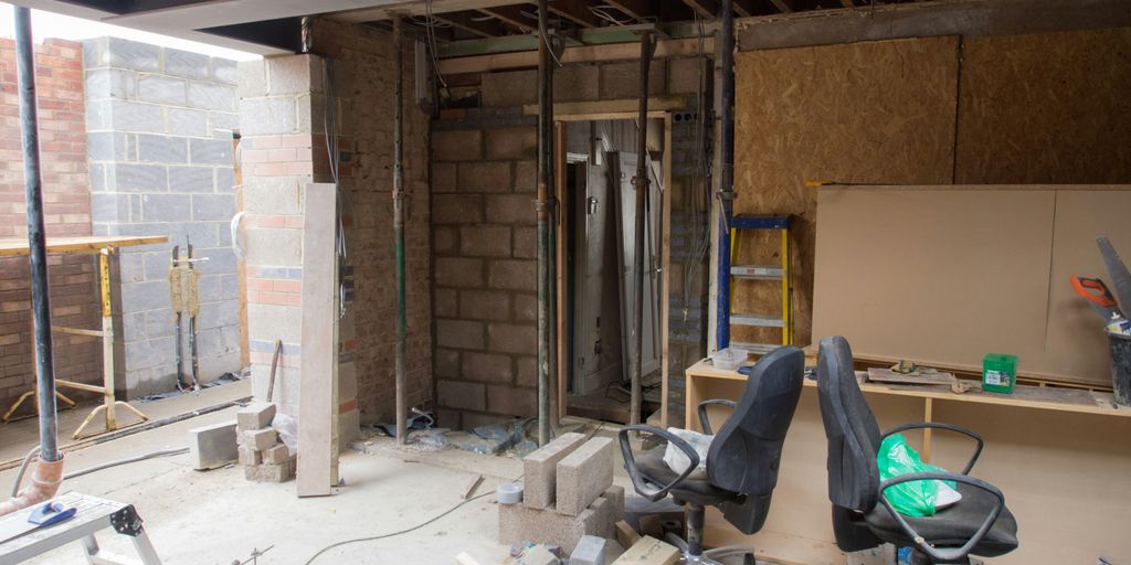 brown short coated dog lying on floor