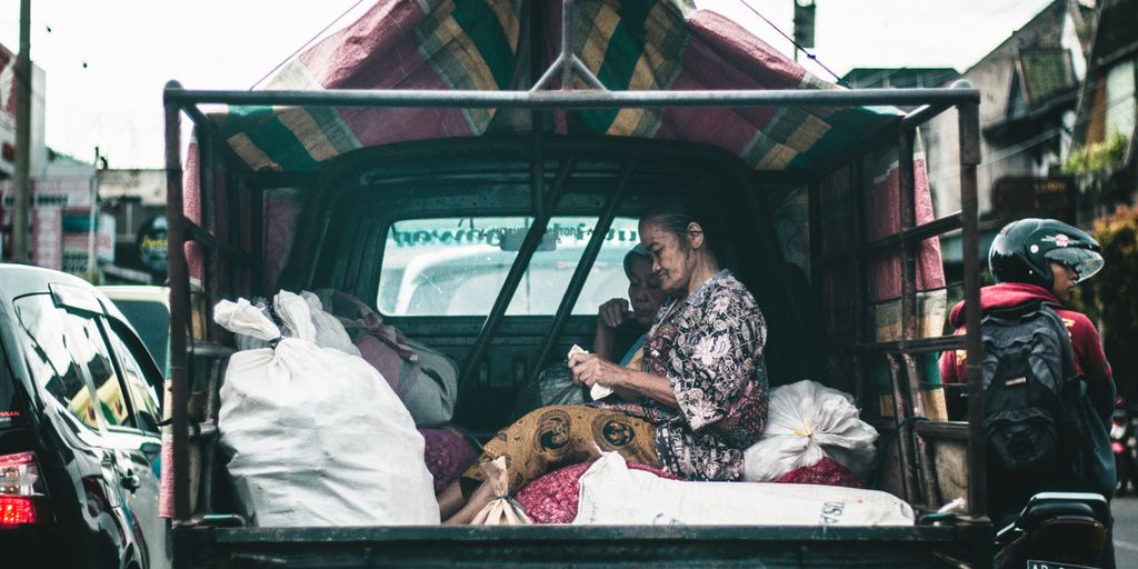 woman seating on drop side truck
