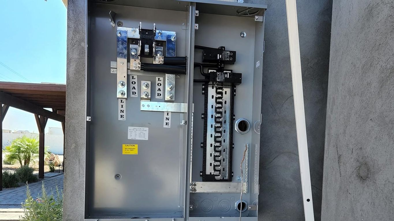 Electrical panel with circuit breakers and wiring displayed open.