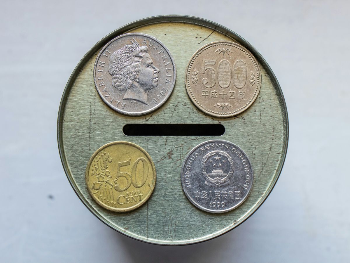 gold round coin on white surface