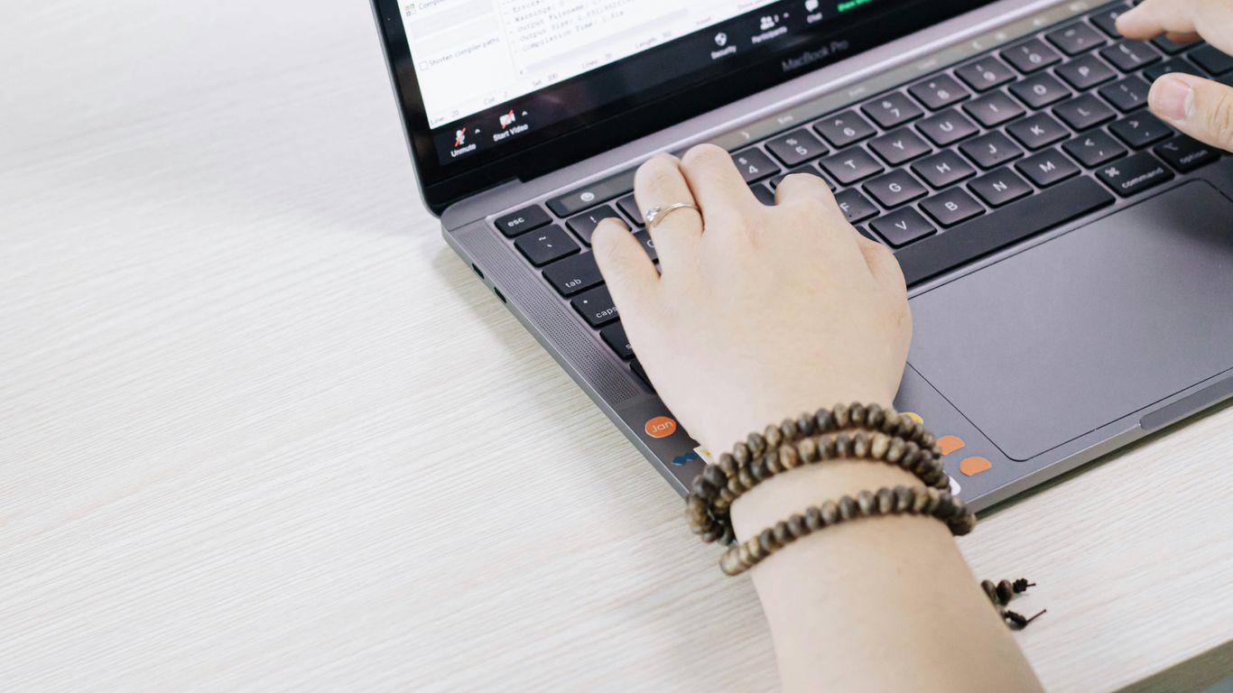 person using black and silver laptop computer