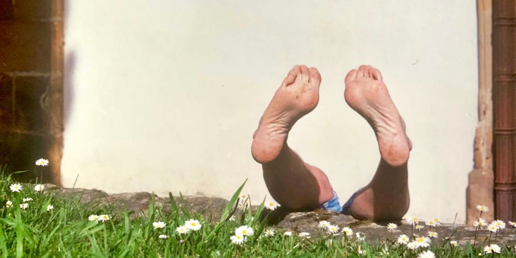 Feet in the air, enjoying the sun.