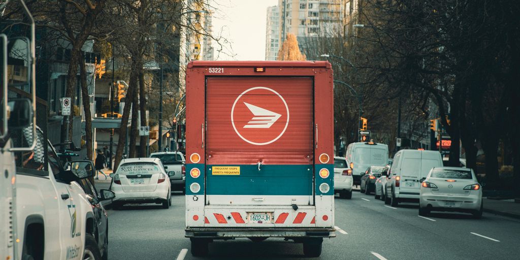 red and white bus on road during daytime